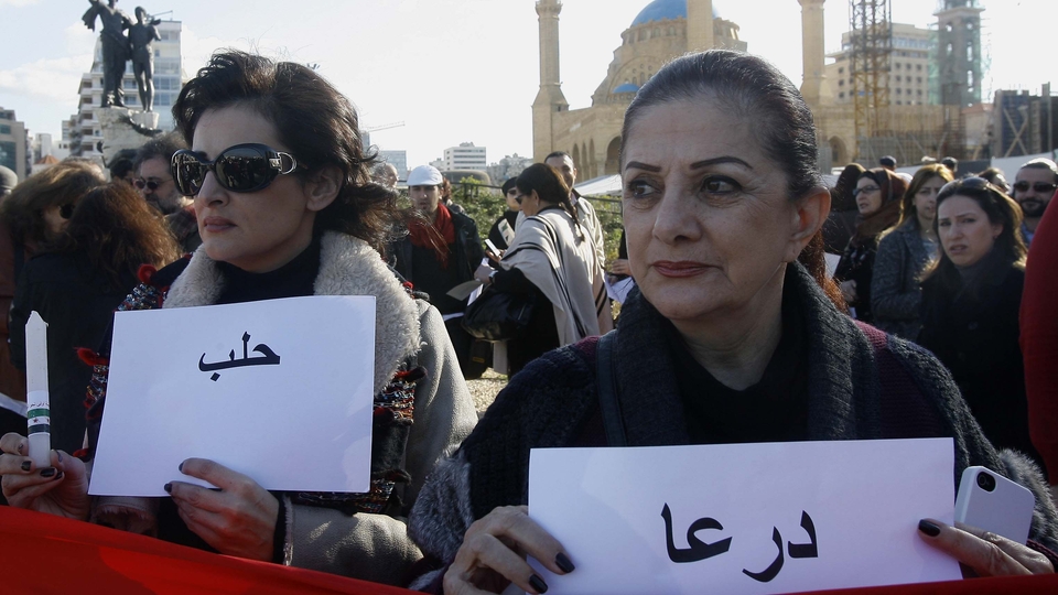 Two women hold vigil for the cities of Dara‘a and Aleppo during the one-year commemoration of the Syrian uprising. Martyrs’ Square, Beirut, Lebanon. March 17, 2012. (Marwan Tahtah/The Public Source)