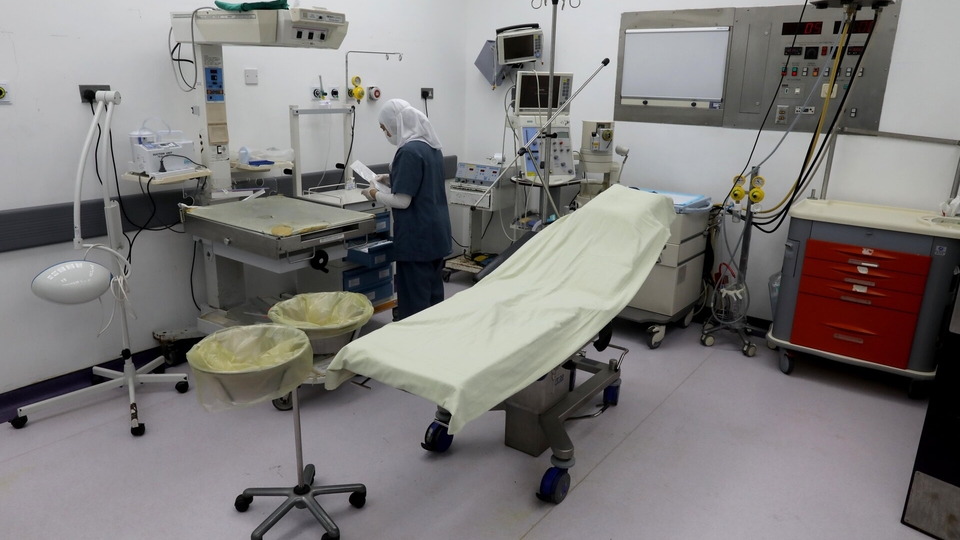 A health worker prepares an operation room.