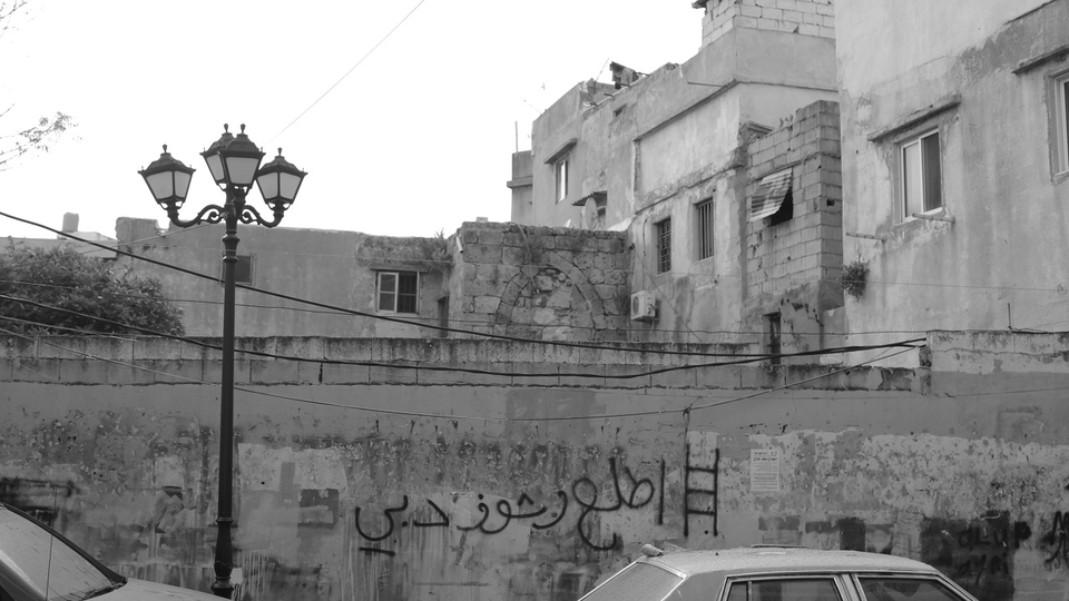 On another wall of a building in the old town of El Mina, one drew a ladder and wrote, “Go up and see Dubai.”