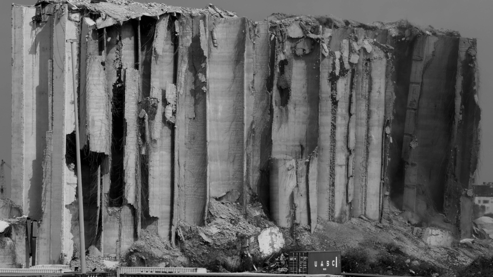 A black and white close-up of the grain silos after the fire died down. 